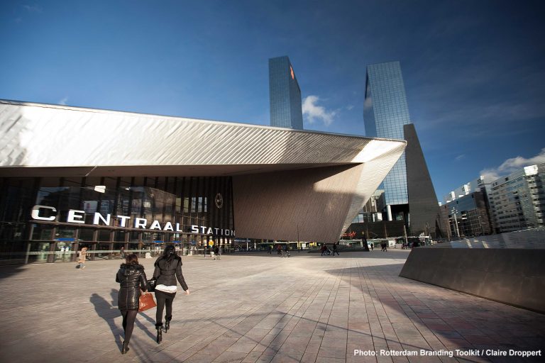 Frontview of the Central Station with on the background the Delftse Poort, containing the office of insurancecompany the Nationale Nederlanden.